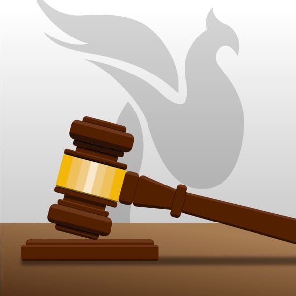 An illustration of a courtroom gavel resting in front of a stylized drawing of a phoenix.